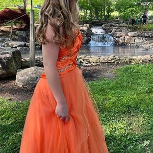 Orange and very puffy it’s super beautiful and has gems on it